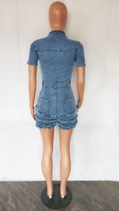 Back view of denim romper with frayed hems, back pockets, and waist belt loops