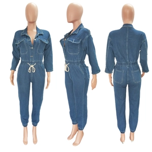 Three views of blue long sleeve denim jumpsuit with drawstring waist and button closure