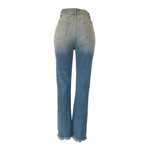 Detail view of light blue flared jeans with frayed hems and back pocket design