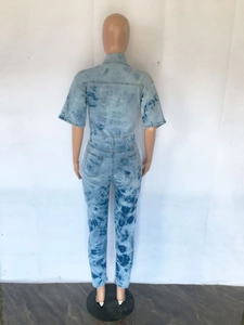 Back view of tie-dye denim jumpsuit featuring short sleeves and slim waist detail
