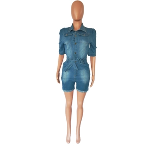 Close-up of slim-fit denim romper featuring classic collar and functional chest pockets