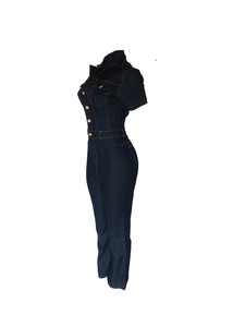 Détail d'une combinaison en jean bleu foncé avec col à revers, boutons métal et poches poitrine