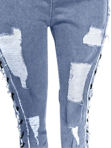 Detail of light blue distressed jeans featuring side eyelets and black lace-up design