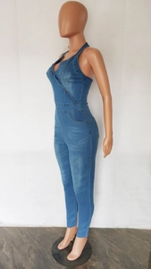 Detailed view of blue washed denim jumpsuit with halter neck and slim fit design