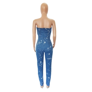 Detail of slim-fit tube denim jumpsuit with white paint splash pattern and back zipper