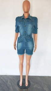 Detailed front view of slim fit denim jumpsuit with button closure and waist tie