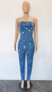 Detailed view of strapless denim jumpsuit with unique white splash paint pattern