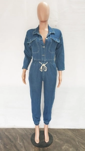 Detail view of dark blue denim jumpsuit with drawstring waist and elastic cuffs