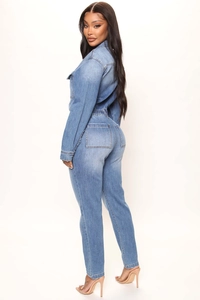 Detail view showing back pockets and slim fit silhouette of a blue denim jumpsuit