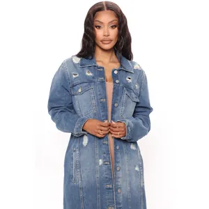 Detail of ripped long denim coat for women featuring distressed holes and metal buttons