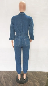 Rear view of dark blue denim jumpsuit featuring elastic waist and functional back pockets