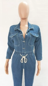 Detail of denim jumpsuit featuring turn-down collar, chest pockets and waist drawstring