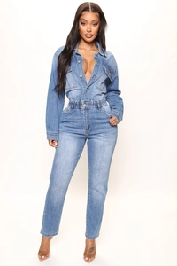 Detail view of light blue denim jumpsuit with long sleeves, button front and cinched waist