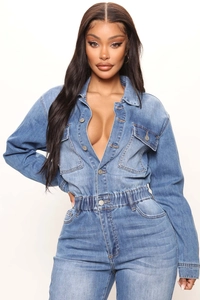 Detailed shot of wash blue denim romper featuring elastic waist and metal button closure