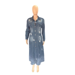 Close-up of distressed denim jacket dress featuring ripped detailing and metal buttons