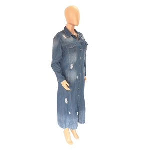 Detailed side view of long washed blue denim trench coat with ripped holes and buttons
