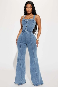 Detail of high-waisted light blue denim jumpsuit featuring metal buttons and slim flare leg