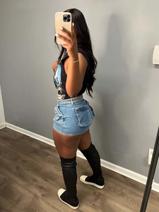 Side view of high-waisted light blue denim shorts with large cargo pockets and metal chain