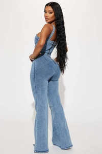 Macro shot of back metal zipper and washed denim texture on a high waist jumpsuit