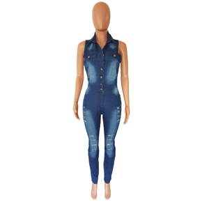 Detail of sleeveless dark blue denim jumpsuit featuring distressed holes and metal buttons