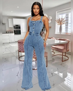 Detail of blue denim jumpsuit featuring a button-down bodice and wide-leg retro cut