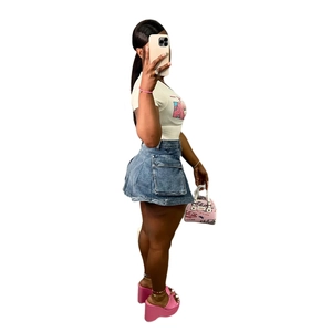 Slim fit denim dress with cargo pockets paired with a graphic tee and pink accessories