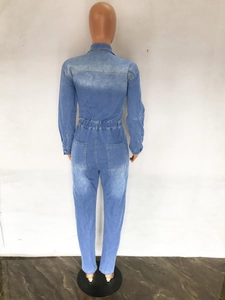Rear view of long sleeve denim jumpsuit featuring elastic waist and washed blue texture