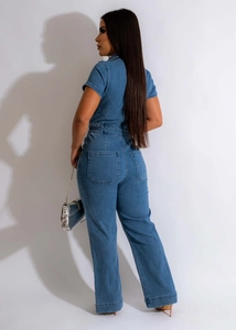 Detail view of denim jumpsuit back with symmetrical pockets and elastic waist design