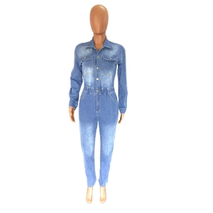Detail of light blue washed denim jumpsuit featuring metallic buttons and chest pockets