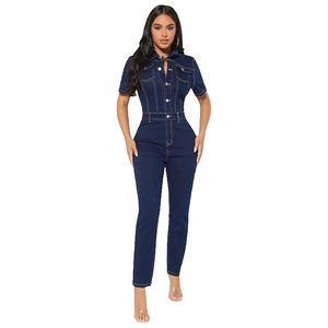 Detailed view of deep blue denim jumpsuit with metallic buttons and contrast stitching