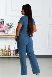 Detail view showing the back profile and large pockets of the denim jumpsuit