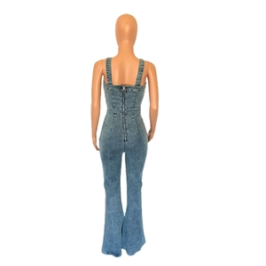 Rear view of light blue flare denim jumpsuit featuring wide straps and back zipper detail