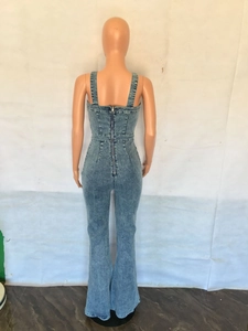 Detailed back view of flared denim jumpsuit with long metal zipper and wide straps