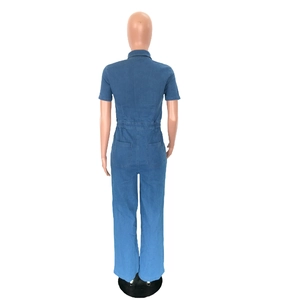 Back view of blue denim short-sleeve jumpsuit featuring elastic waist and utility pockets