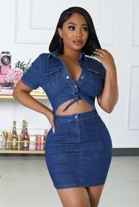 Detailed view of the cropped denim shirt and high-waisted mini skirt set in washed blue
