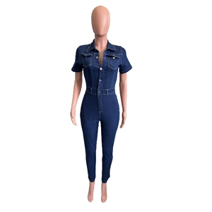 Detailed view of dark blue denim jumpsuit featuring metal buttons and front chest pockets