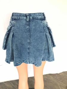 Back view of blue denim mini skirt featuring large cargo pockets and pleated hem detail