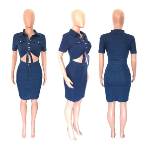 Detail view of dark blue denim mini dress featuring side cut-outs and lace-up design