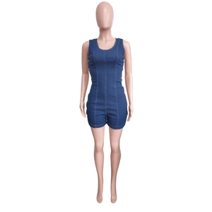 Detail of blue denim romper featuring vertical seams and circular metal button accents