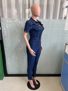 Detail of slim fit dark blue denim jumpsuit with short sleeves and front pockets