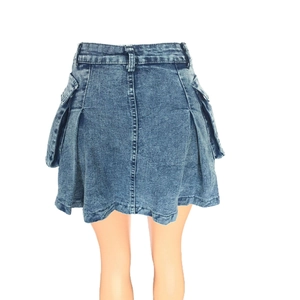 Detail of blue denim mini skirt with utility cargo pockets and pleated A-line hem