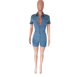 Detail view of a medium blue denim romper with short sleeves and front button closure