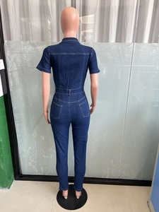 Rear view of dark blue denim jumpsuit with short sleeves and symmetric back pockets
