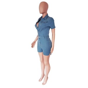 Detail of blue denim romper featuring side slits, waist-shaping cut and metal buttons