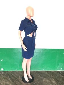 Detail of slim fit dark blue denim two-piece set with short sleeve shirt and pencil skirt