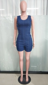 Detail of slim fit dark blue denim romper featuring metal double-breasted buttons
