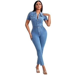 Detailed view of light blue short-sleeved denim jumpsuit with pockets and slim fit design