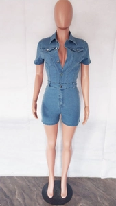 Detail of light blue denim short jumpsuit with turn-down collar and metal buttons