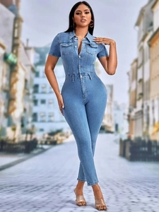 Detail of short sleeve denim jumpsuit featuring turn-down collar and chest pockets