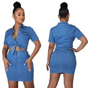 Detail view of a two-piece washed denim set showing front crop top and back of mini skirt
